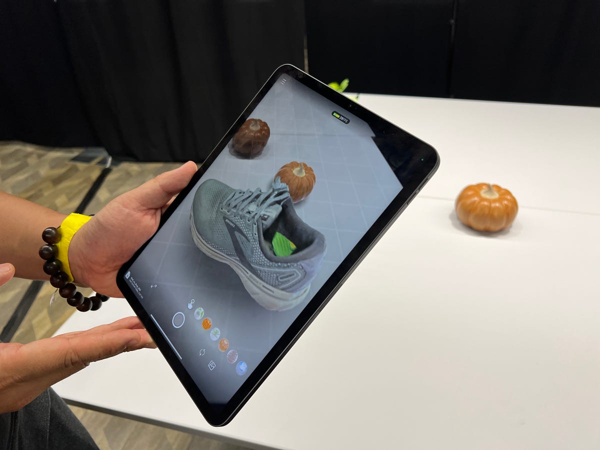A tablet showing a 3D image of a shoe