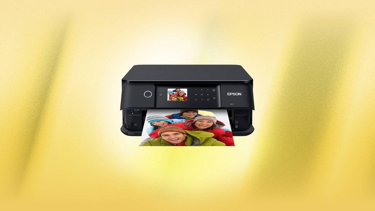 An Epson photo printer against a yellow background.