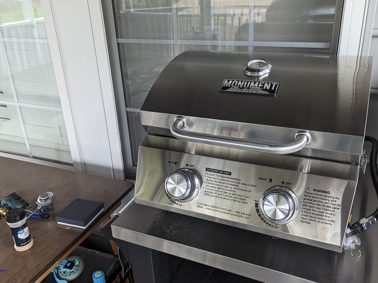 Small silver grill on a metal table
