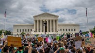 People protest in response to the Dobbs v Jackson Women's Health Organization ruling in front of the U.S. Supreme Court