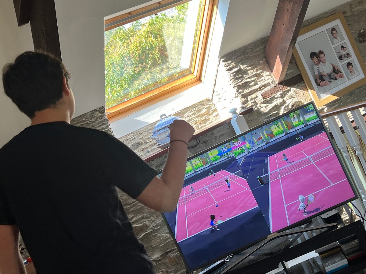 teenager playing switch sports tennis