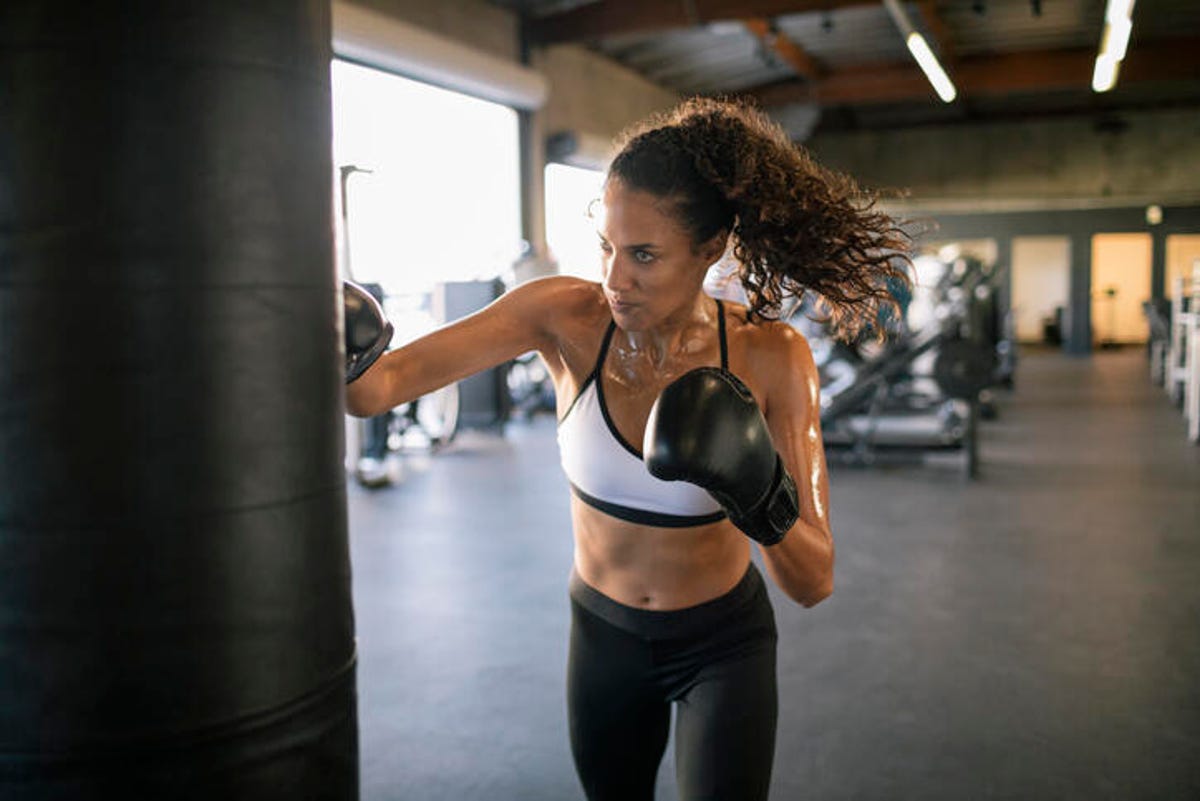 Woman boxing with a heavy bag
