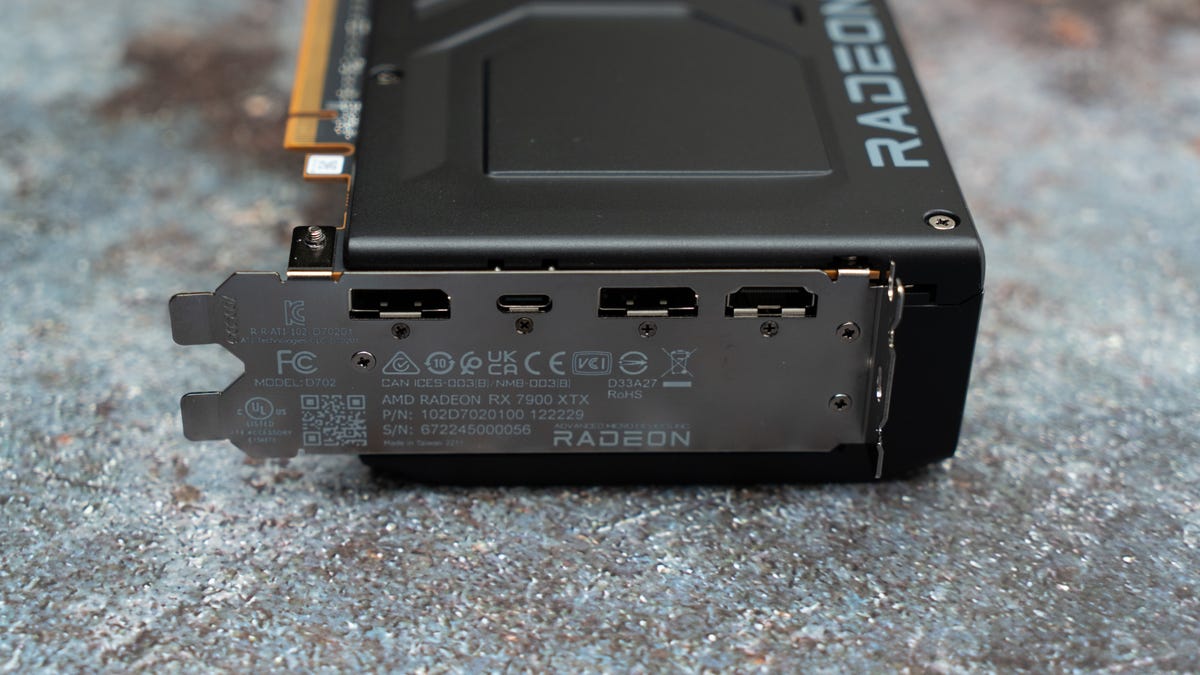 The RX 7900 XTX lying on its side showing the displayport, hdmi and USB-C connectors