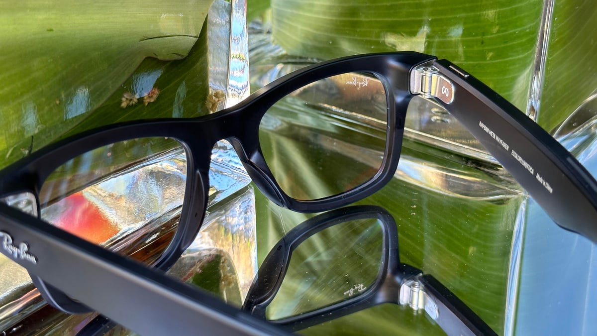 Looking at a pair of black Ray-Ban glasses on a table, through the lenses