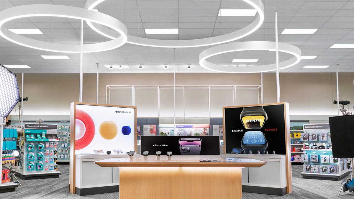 A counter with Apple products and screen displays in Target store