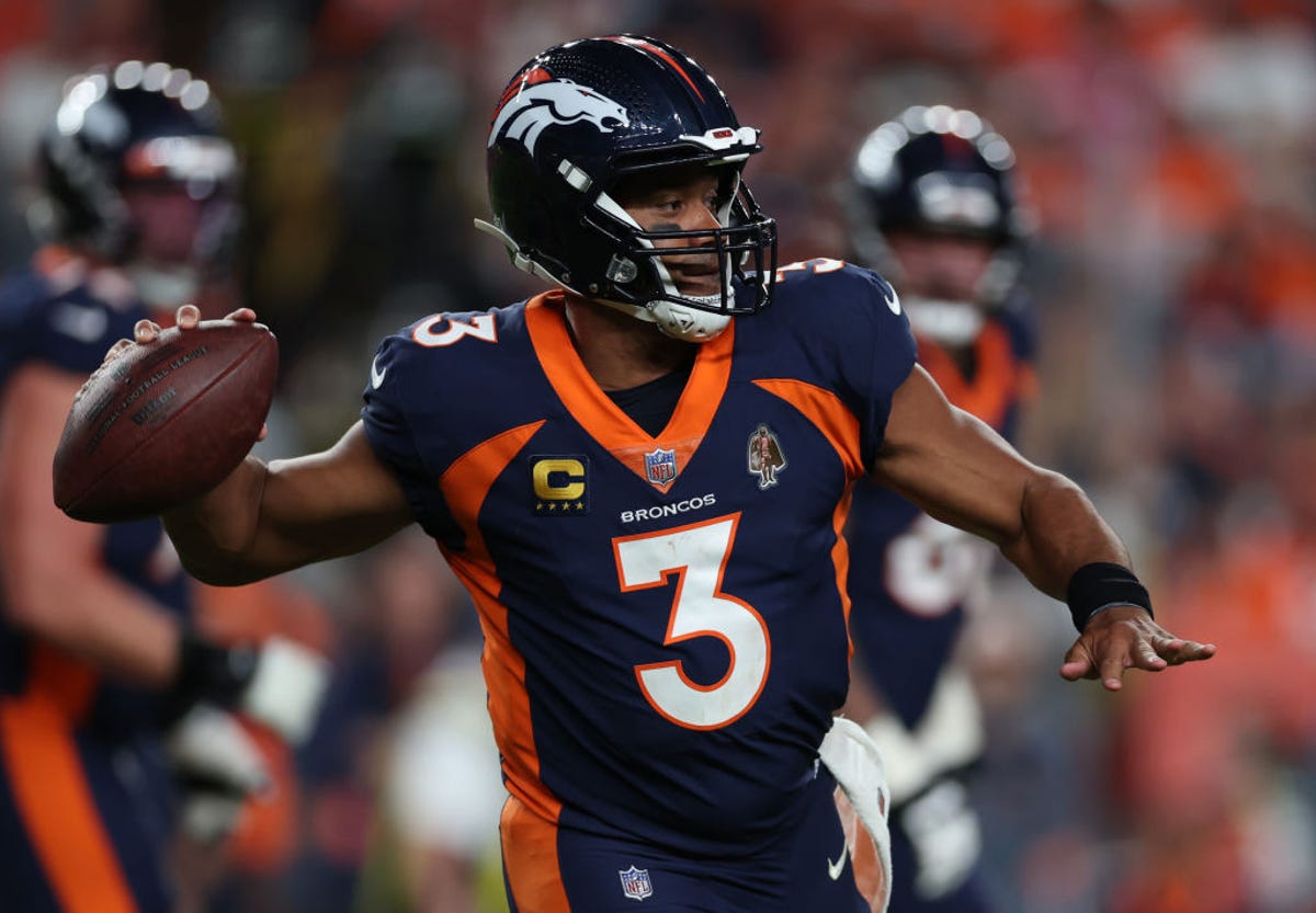 Quarterback Russell Wilson of the Denver Broncos moves to throw the football