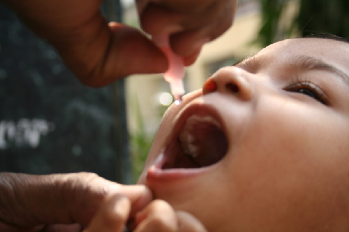 A child receiving oral polio vaccine