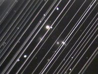 <p>This image of a distant galaxy group from Arizona's Lowell Observatory is marred by diagonal lines from the trails of Starlink satellites shortly after their launch in May.</p>