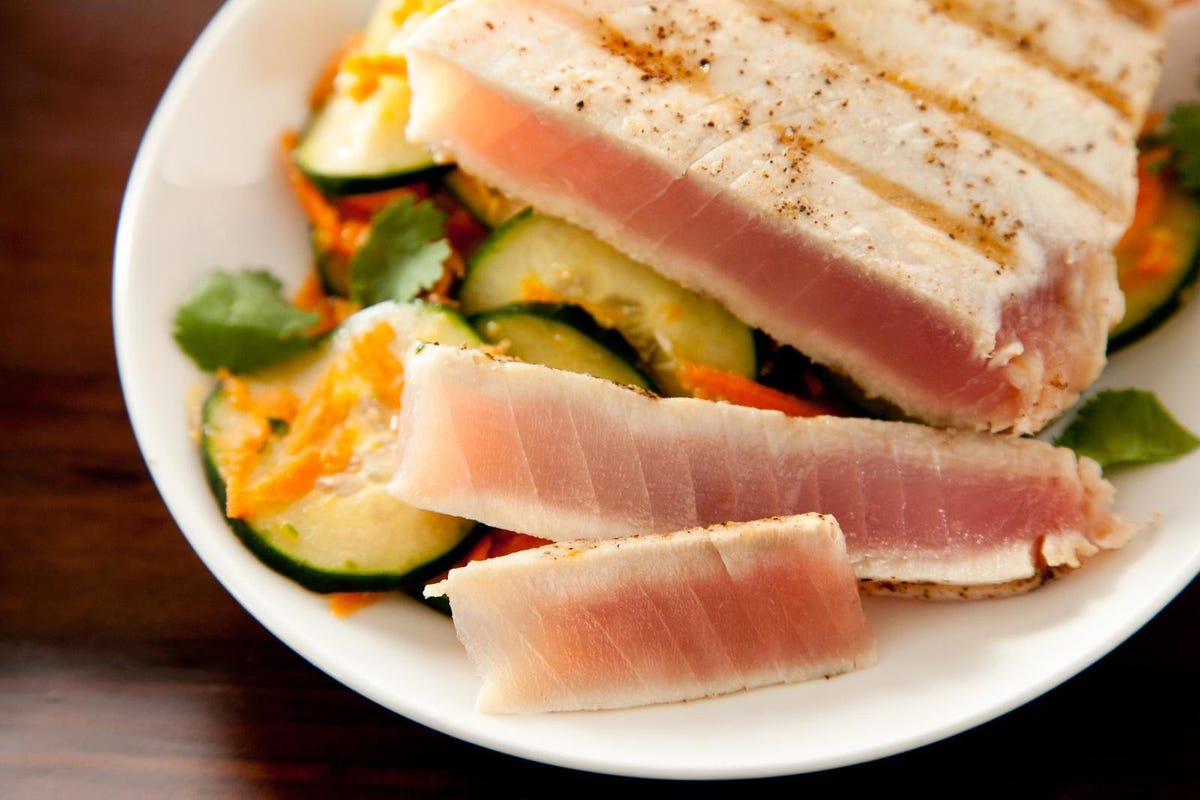 sliced tuna over cucumber salad