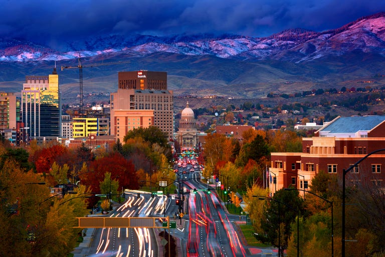 Downtown Boise at sunset with fresh snow on the foothills in the distance.