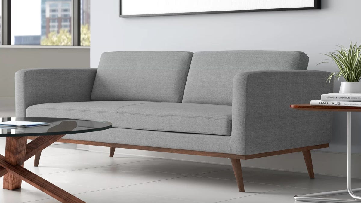 A grey two-person sofa in a modern living room.