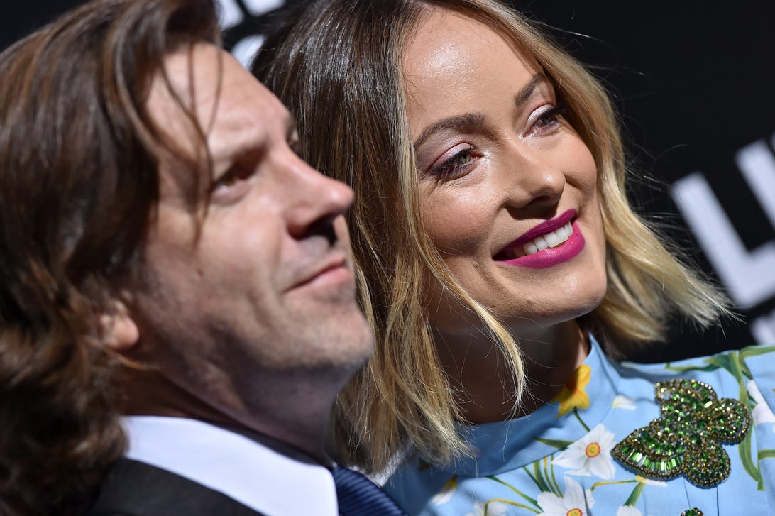 Close-up of Jason Sudeikis and Olivia Wilde smiling at a premiere in 2018.