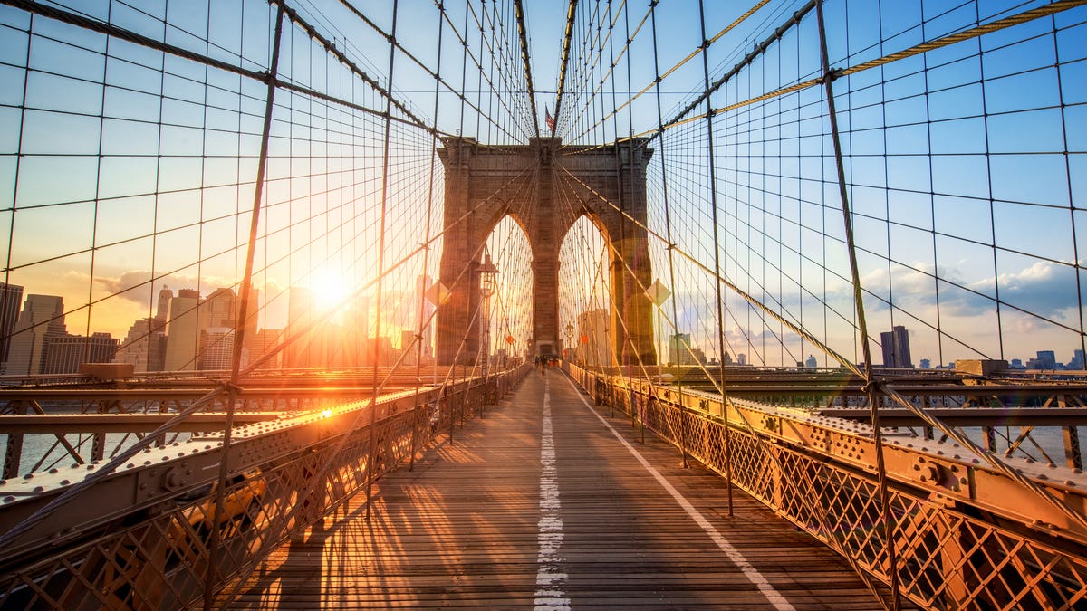 The sun shines over the Brooklyn Bridge in New York.