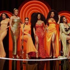 6 women stand against orange background - Drew Sidora, Marlo Hampton, Sheree Whitfield, Kandi Burruss, Kenya Moore, Sanya Richards Ross