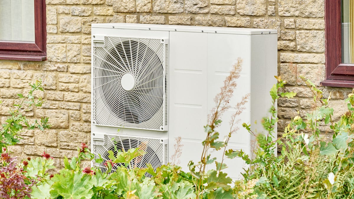 a heat pump installed on the exterior of a brick home