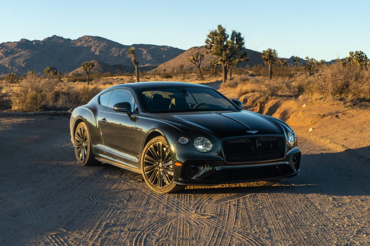 Front 3/4 view of a green 2022 Bentley Continental GT Speed Coupe in the desert