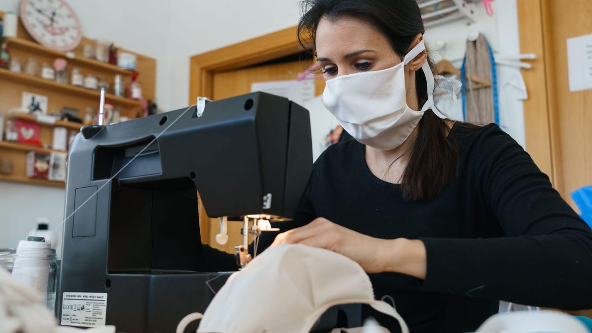 A woman sewing handmade face masks in Spain last month. The US Centers for Disease Control and Prevention now recommends that people in the states wear nonmedical, cloth face masks when they leave home. But medical-grade masks, like N95 respirators, shoul