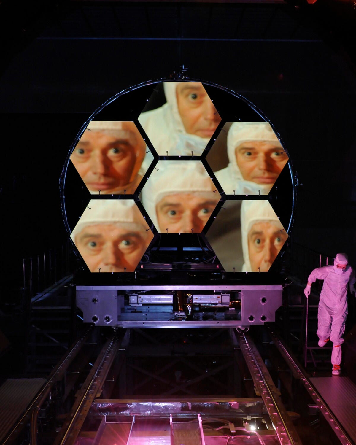 One of JWST's scientists is seen reflected in the telescope's mirrors.