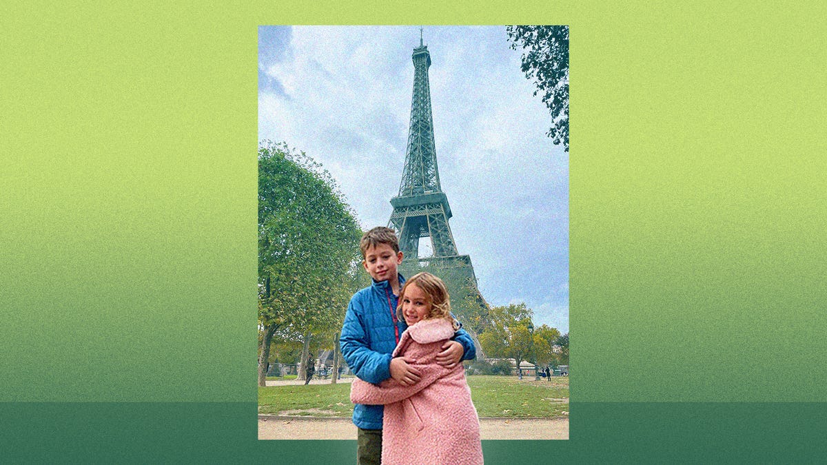 Farnoosh&apos;s two kids in front of the Eiffel Tower