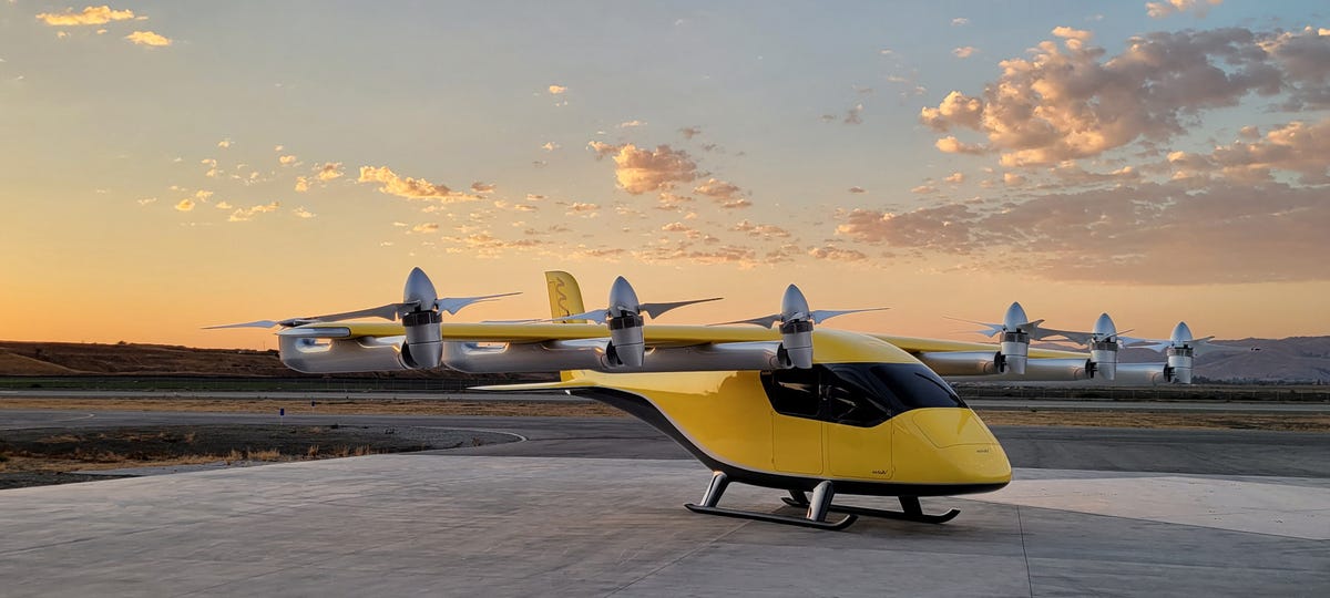 The Wisk Gen 6 autonomous air taxi shown on an outdoor landing pad.