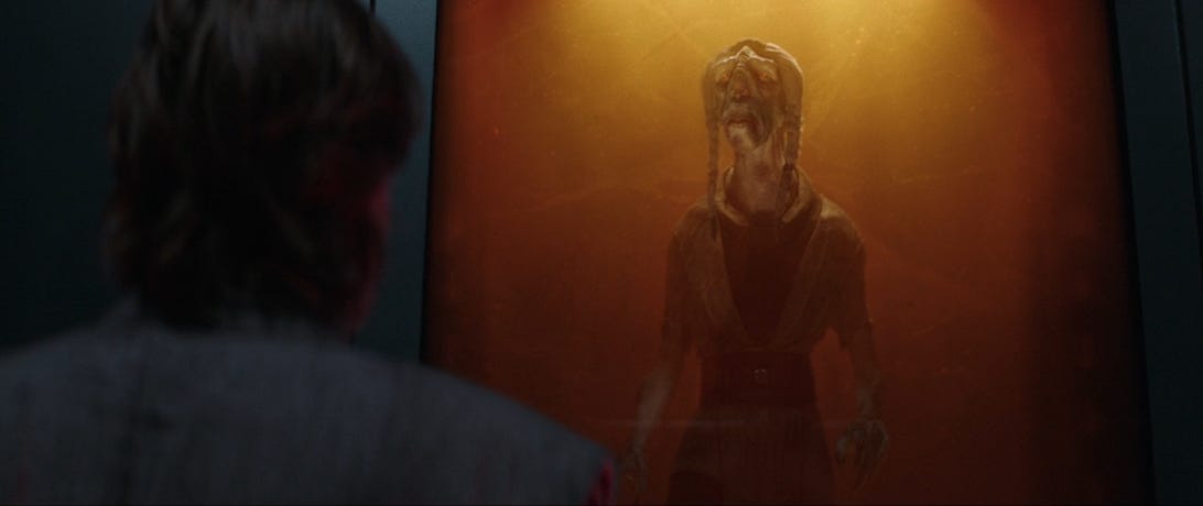 Obi-Wan Kenobi looks at dead Jedi Master Tera Sinube as he floats in a tank
