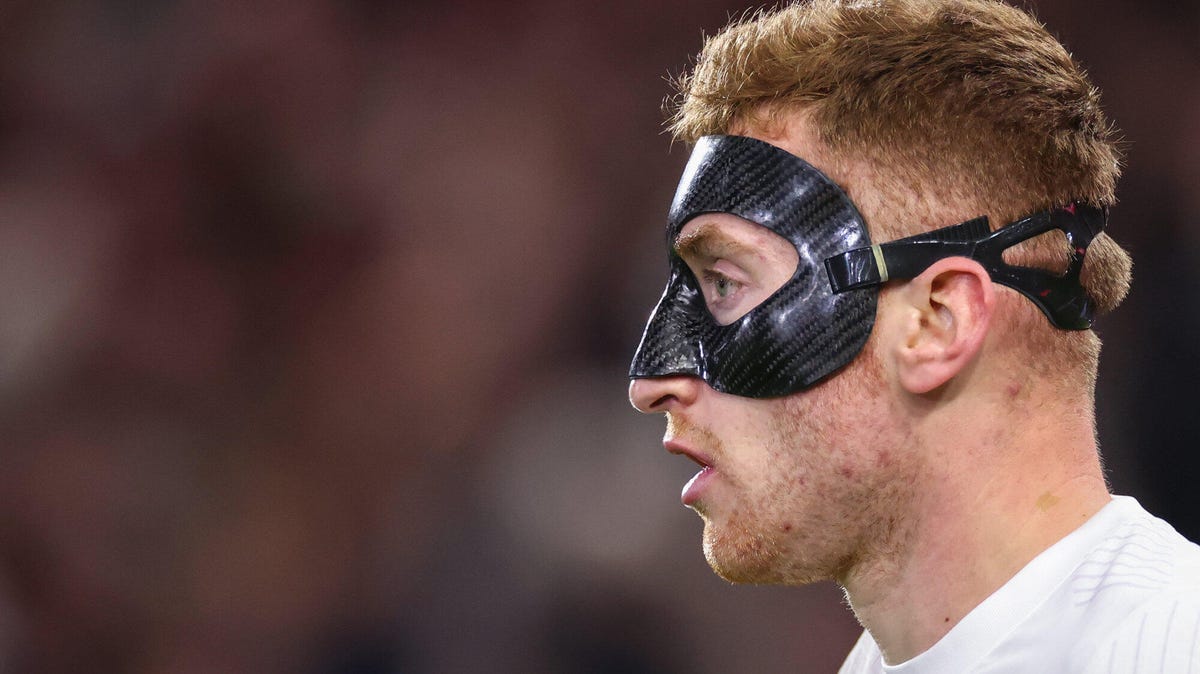 Side-on image of Tottenham Hotspur's Dejan Kulusevski wearing a protective face mask.