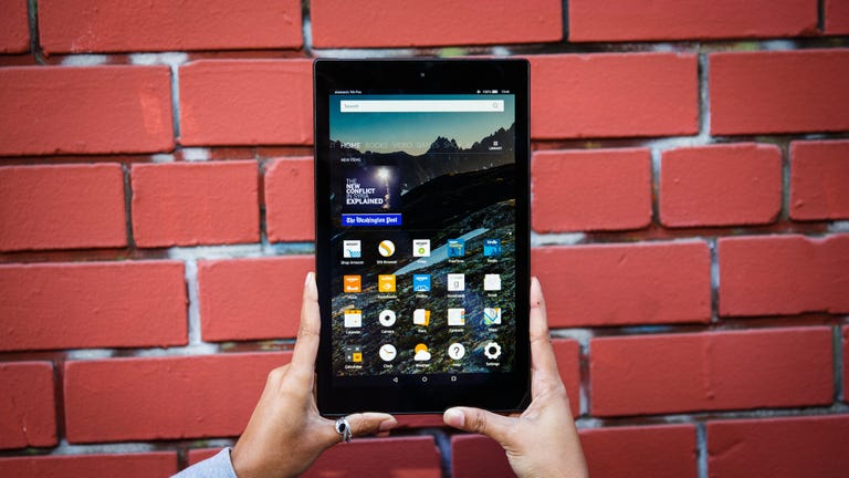 Amazon Fire HD 10 tablet in front of a brick wall