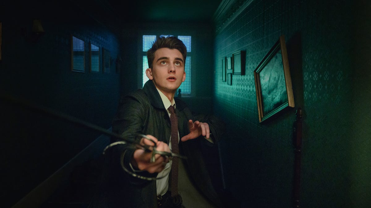 Cameron Chapman as Anthony Lockwood, holding a sword out in a dark corridor