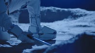 A scientists in a spacesuit's boots are seen on what looks like lunar soil.