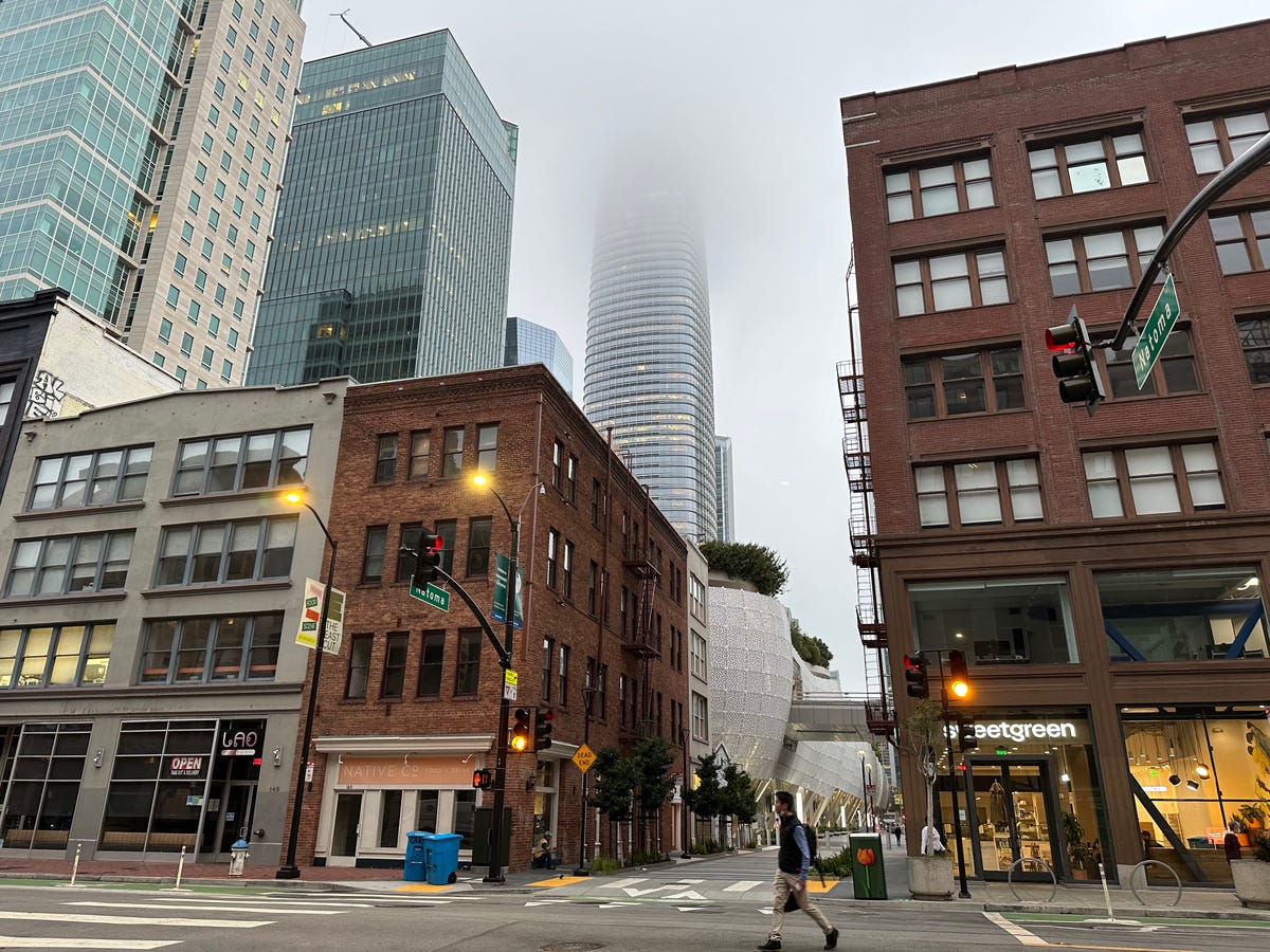 A bunch of building with a skyscraper covered in fog