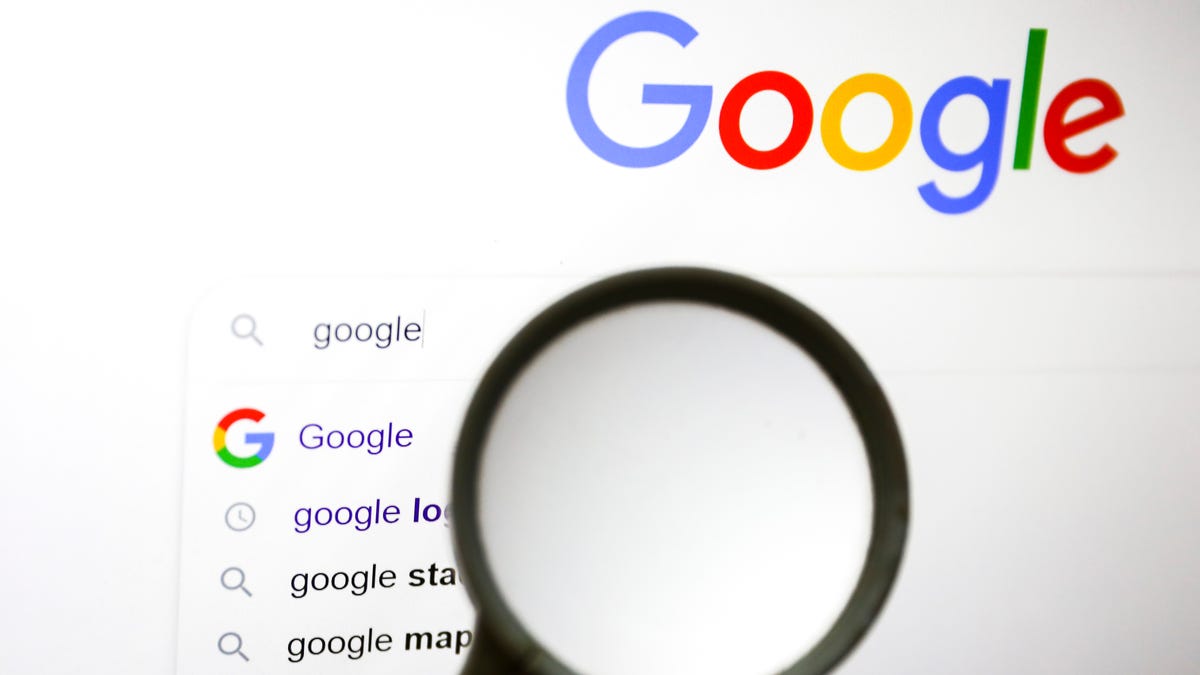 Image of a magnifying glass hovering over Google Search results