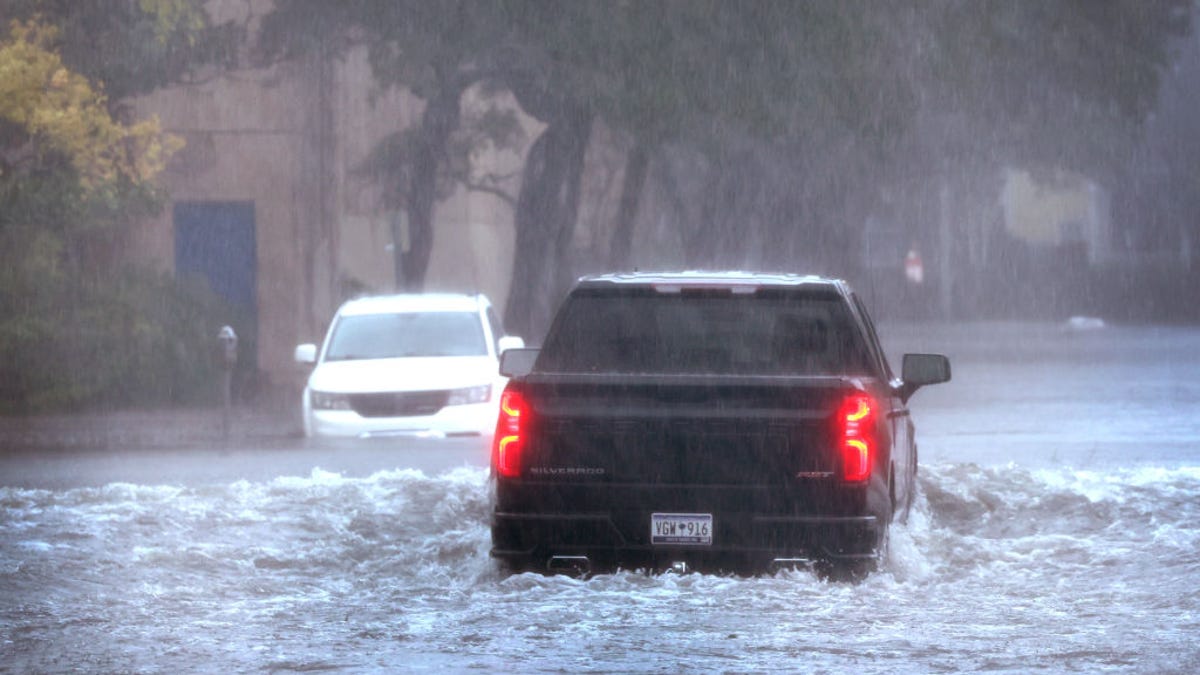 An image of a pickup truck driving through Hurricane Ian floodwaters.