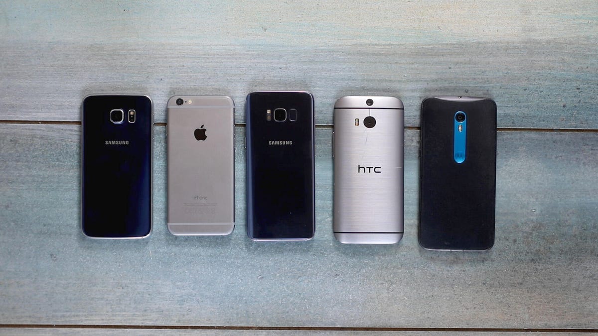Five phones laying flat on a table