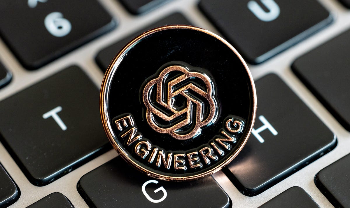 An OpenAI lapel pin with the company's logo and the word 