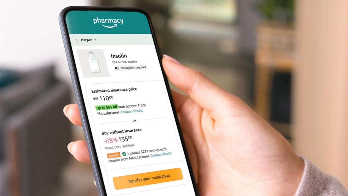 A person's hand holding a phone screen displaying an Amazon pharmacy order