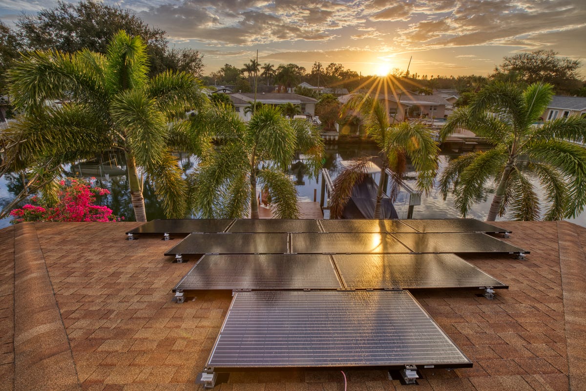 Solar panels on a residential house in Florida with the sun just starting to rise.