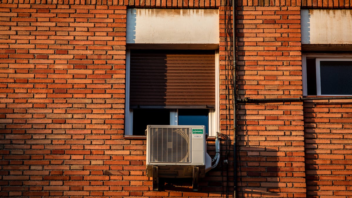 An air conditioning unit under the window of a residential apartment building in Barcelona, Spain, on Thursday, July 29, 2021