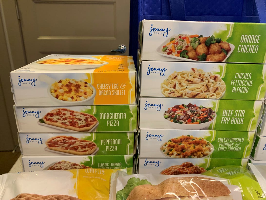 a stack of Jenny Craig lunch meals in their boxes