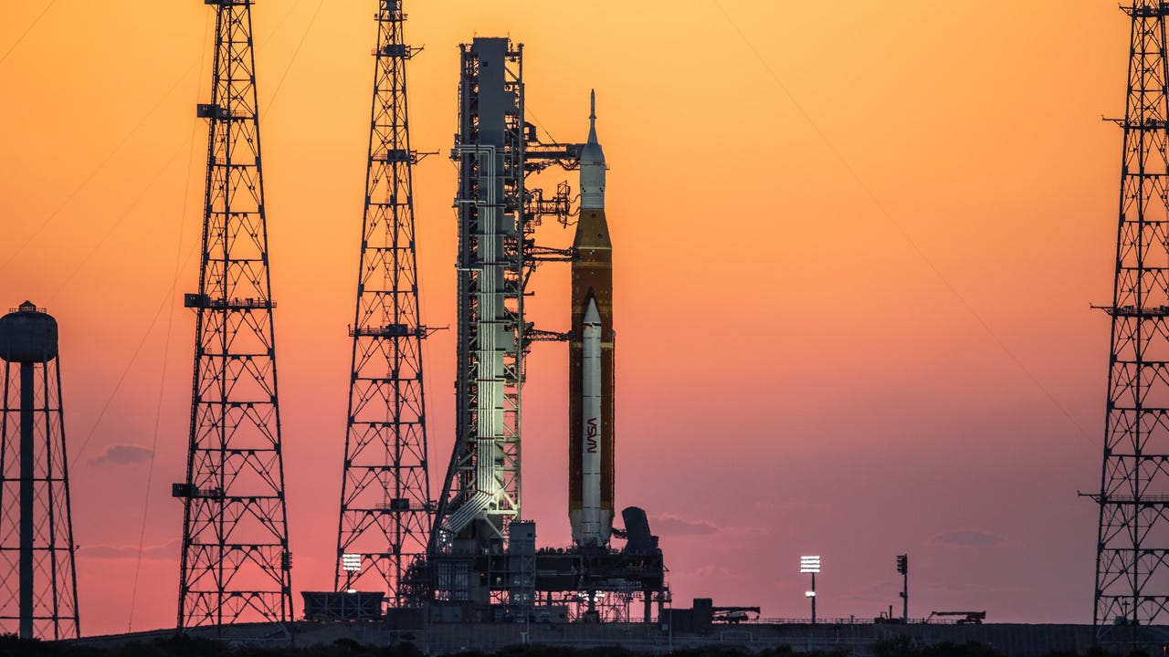 The sun rises as the Artemis I rocket sits at the launch pad at NASA's Kennedy Space Center in Florida.