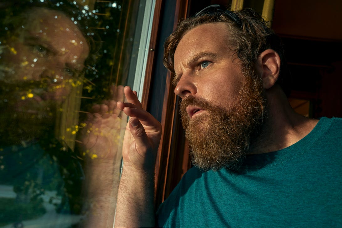 Adam Bartley looks out a window.