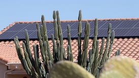 Solar panels on the roof of a brick house.