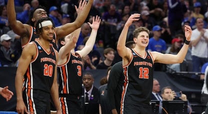 Princeton basketball players celebrate a March Madness win