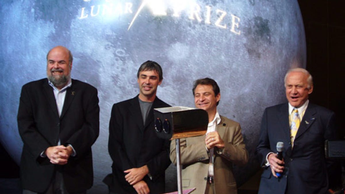 X Prize President Bob Weiss (far left) announcing the X Prize Competition with (from left to right) Google co-founder Larry Page, X Prize Founder Peter Diamandis, and Buzz Aldrin in 2007.