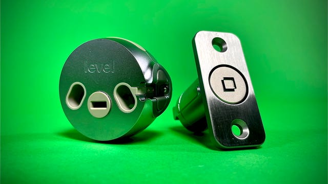 The Level Lock's deadbolt and interior cylinder against a green backdrop.