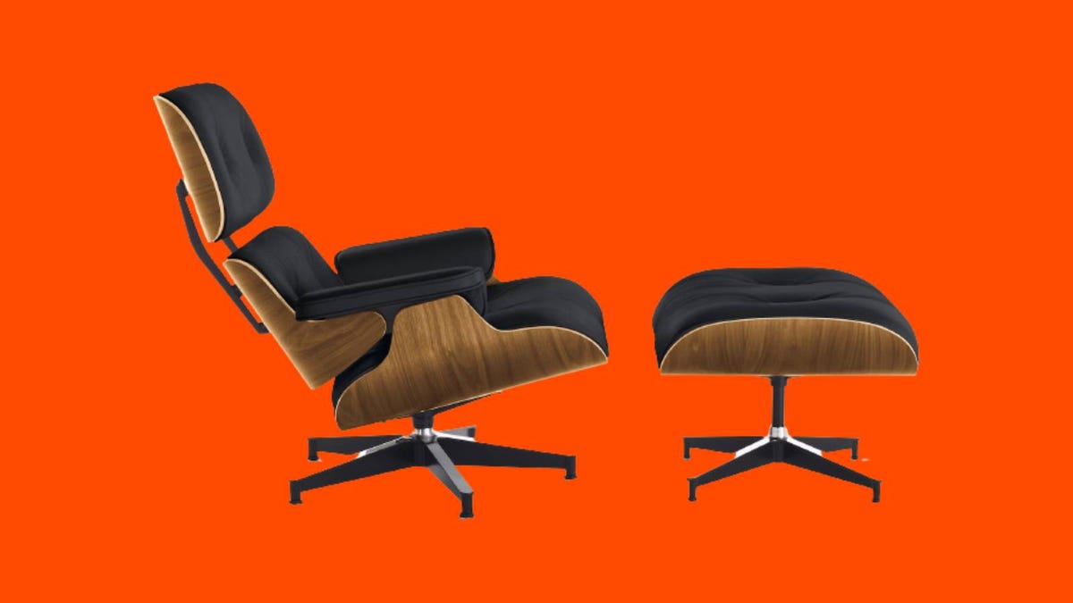 An Eames lounge chair and ottoman against an orange background.