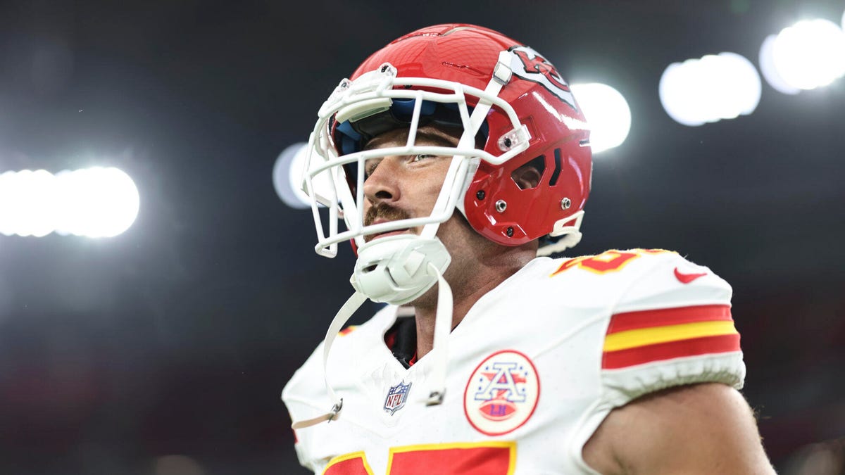 Side on image of Kansas City Chiefs Tight End Travis Kelce wearing a helmet, looking forwards.