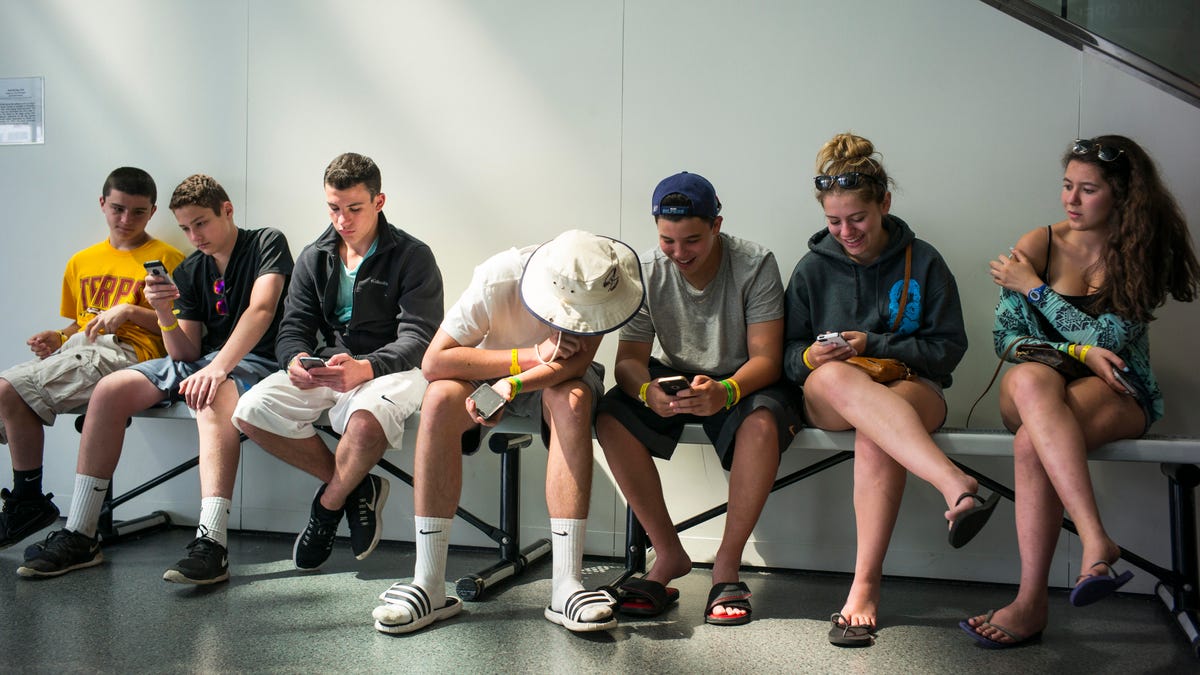 Teens Look At Their iPhones