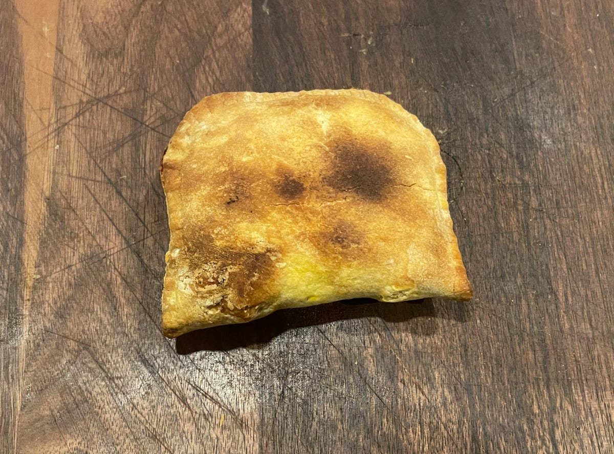 A toasted pastry with dark brown spots.