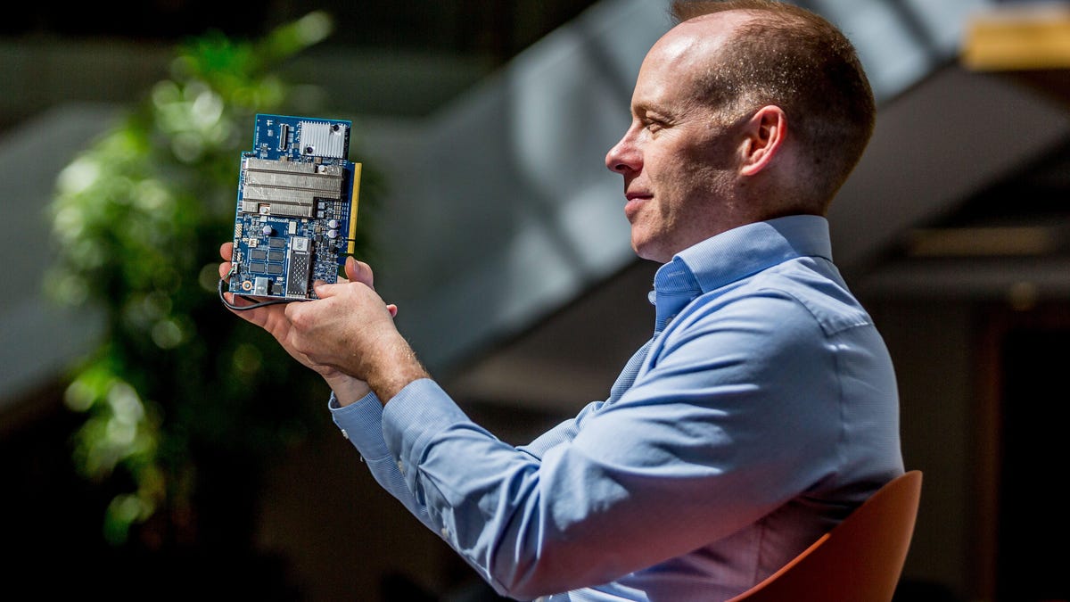 Doug Burger, a distinguished engineer who's led Microsoft's work to adapt AI to FPGA chips, holds a Project Brainwave electronics board.
