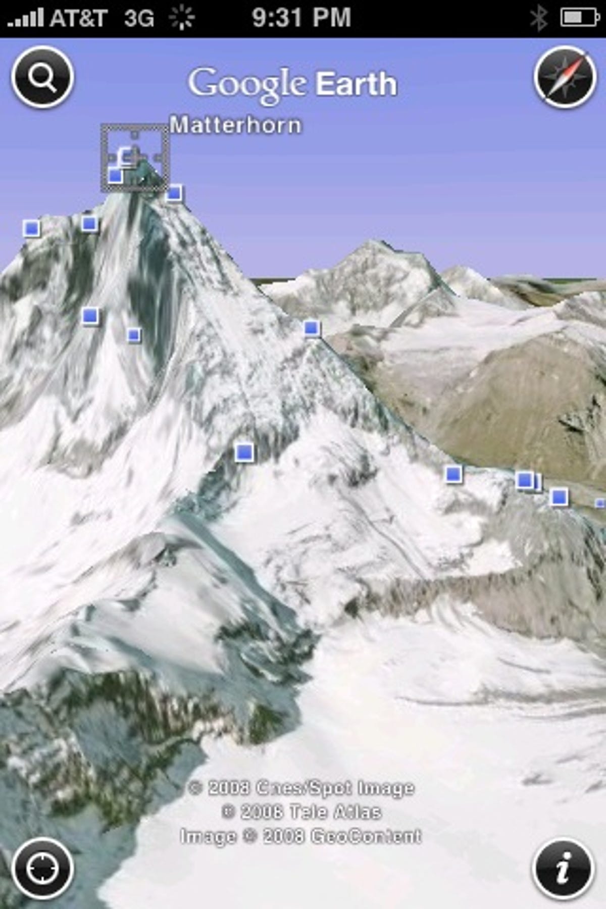 Google Earth for the iPhone can show satellite views of the world in 3D, in this case the Matterhorn, and dots the display with blue squares showing geotagged Panoramio photos.